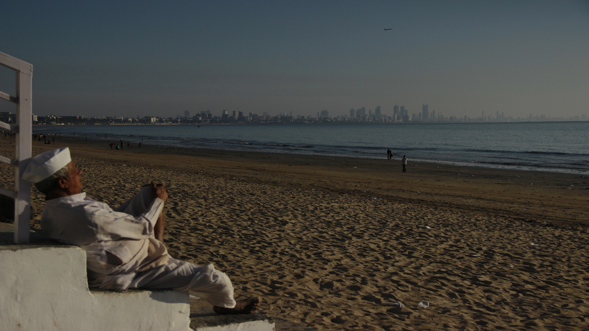 A man sitting on the beach looking at the sea and sharing his story